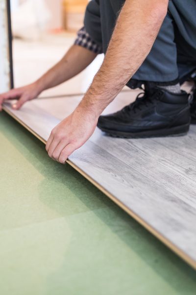Vinyl flooring provides a budget-friendly, durable, and stylish option for homeowners. This image captures the installation process, highlighting the versatility and ease of upgrading your floors with modern vinyl planks.